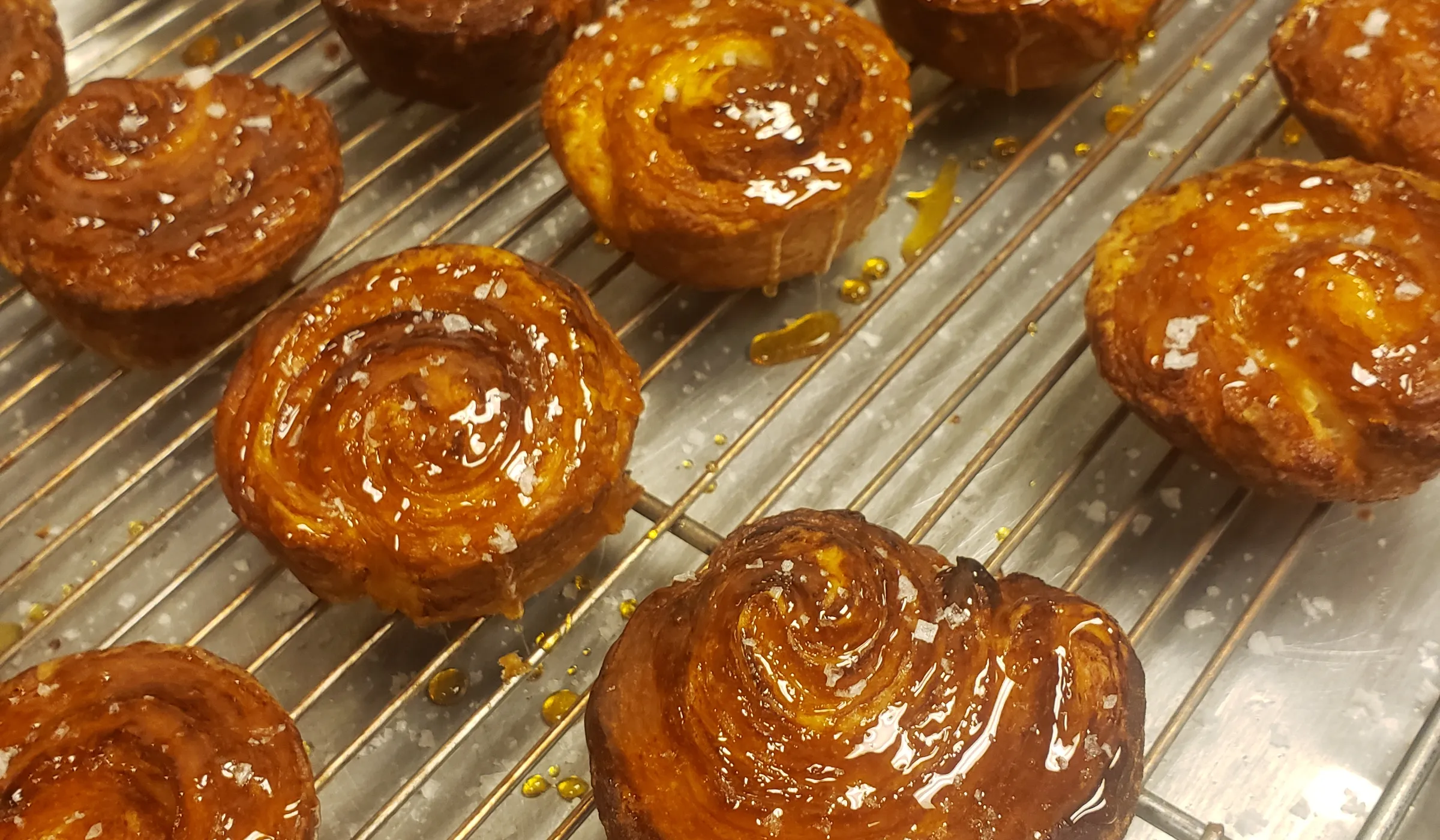 A rack of caramelized kouign-amann, fresh from the oven