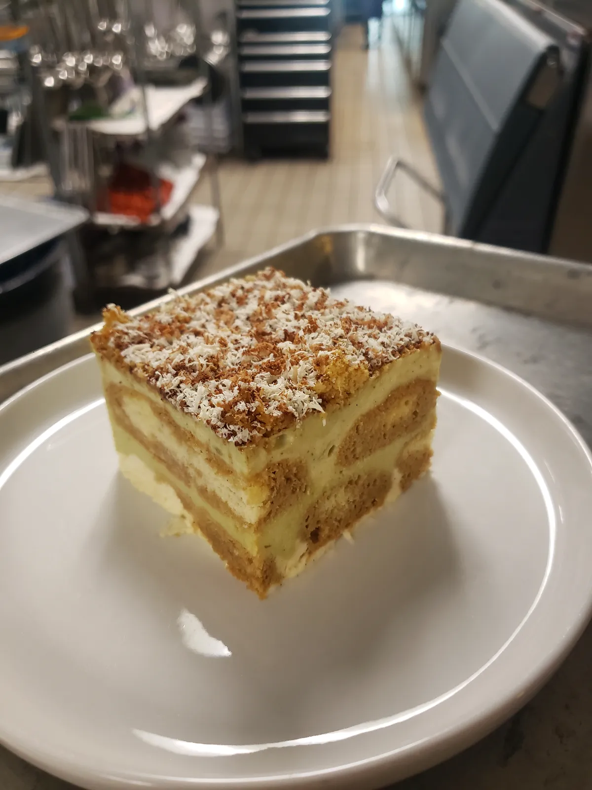 A slice of layered cake on a white plate