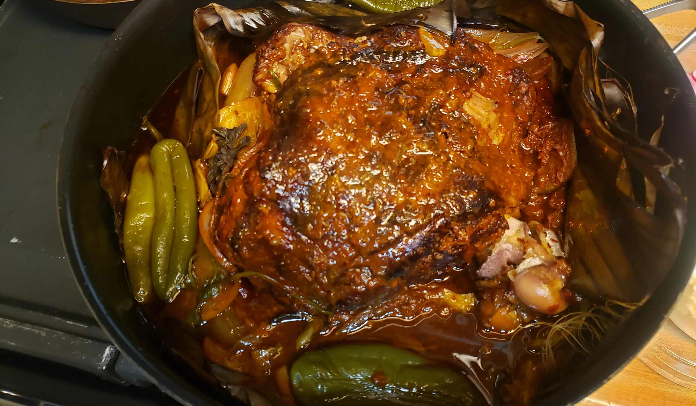 Roast pork in banana leaves with peppers, straight from Kyle's pot